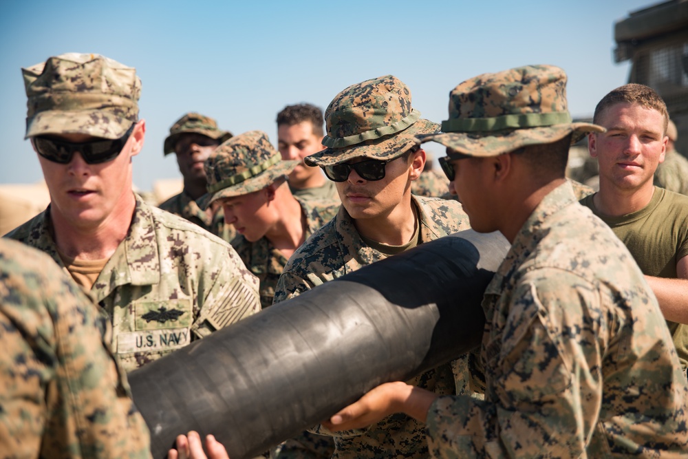 Sailors, Marines Carry Hose for OPDS Operations