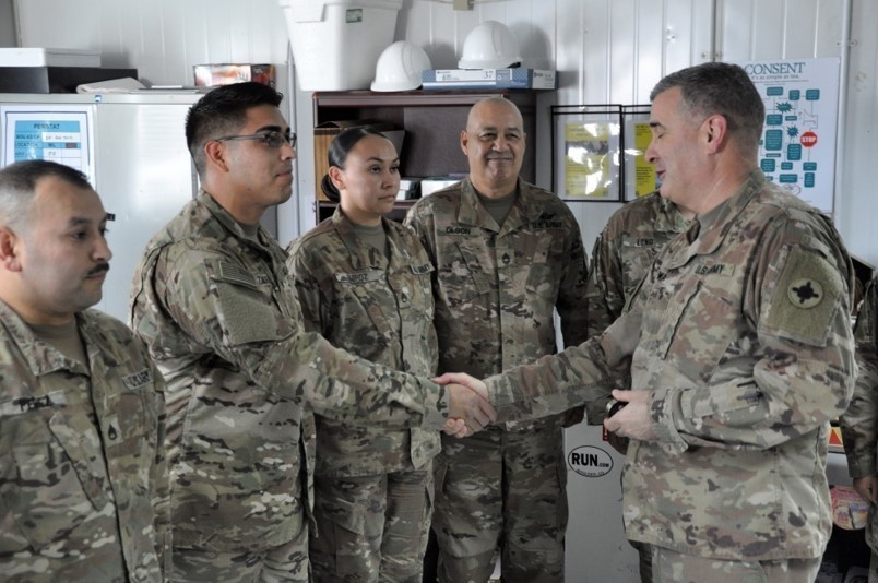 184th Sustainment Command, presents a coin