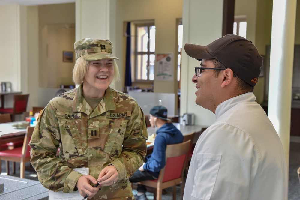 Commanding General's Summertime Competition: Capt. Amanda Cain and Staff Sgt. Jose Montero discuss available nutrition at Wings of Victory Dining Facility