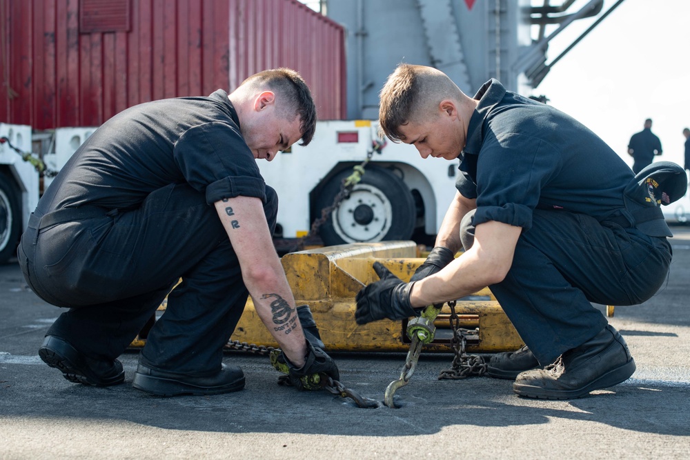 U.S. Sailors chain equipment