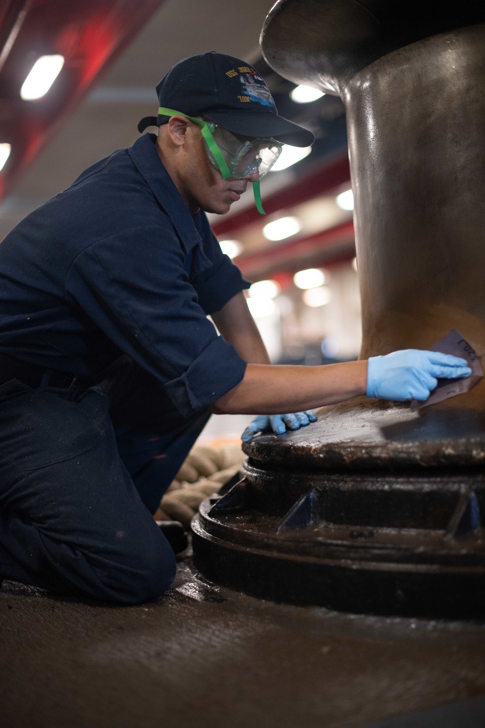 U.S. Sailor cleans winch