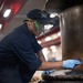 U.S. Sailor cleans winch