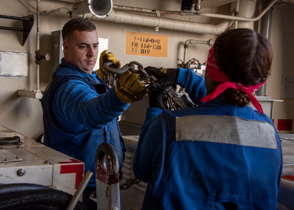 Sailors Work in Hangar Bay of USS Somerset