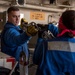 Sailors Work in Hangar Bay of USS Somerset