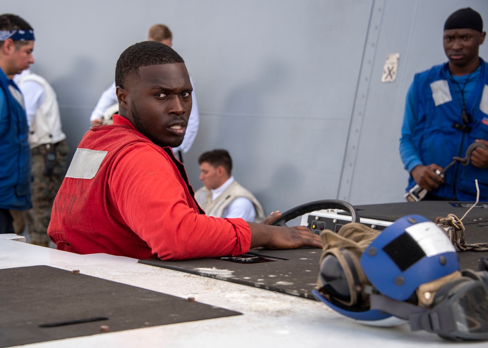 Sailor drives an aviation tractor on the flight deck  USS Somerset