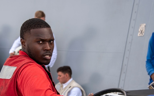 Sailor drives an aviation tractor on the flight deck  USS Somerset