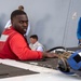 Sailor drives an aviation tractor on the flight deck  USS Somerset