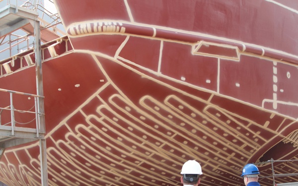 Brig. Gen. Geck, commanding general of the 103rd Expeditionary Sustainment Brigade looks at U.S. Army Logistics Support Vessel SP4 James A. Loux while undergoing renovation in drydock on 16 Sept. 2019 in Kuwait. (U.S. Army photo by Staff Godot G. Galgano)