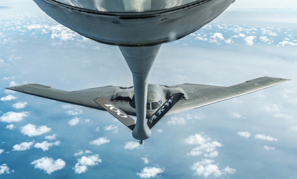 A B-2 Bomber from Whiteman AFB and a KC-135 Stratotanker fly above England during a training mission