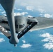 A B-2 Bomber and a KC-135 Stratotanker fly over England during a training mission