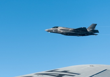 A RAF F-35 Lightning II flies with a KC-135 Stratotanker over England during a training mission