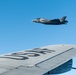 A RAF F-35 Lightning II flies with a KC-135 Stratotanker over England during a training mission