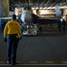 U.S. Navy Sailor guides a training aircraft