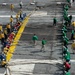 U.S. Sailors pull out a safety net during a barricade drill