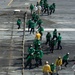 U.S. Sailors run back to their stations during a barricade drill