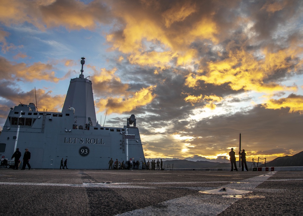 Sailors observe sunrise on the flight deck of USS Somerset