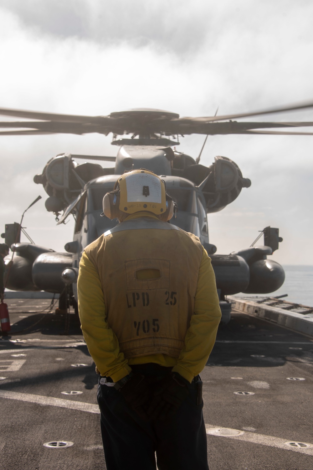 Sailor prepares to direct a Sea Stallion USS Somerset