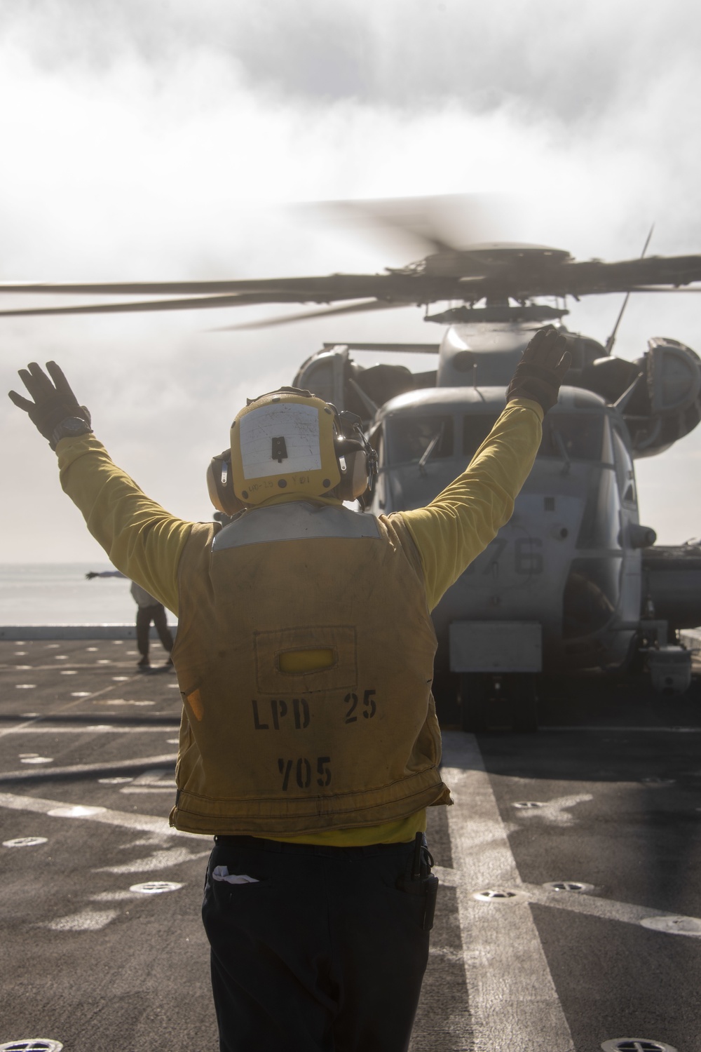 Sailor directs a Sea Stallion USS Somerset