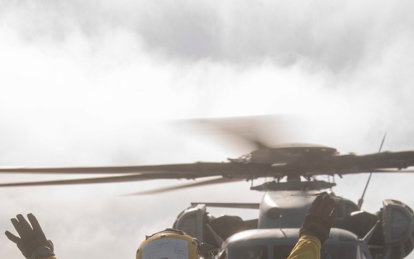 Sailor directs a Sea Stallion USS Somerset