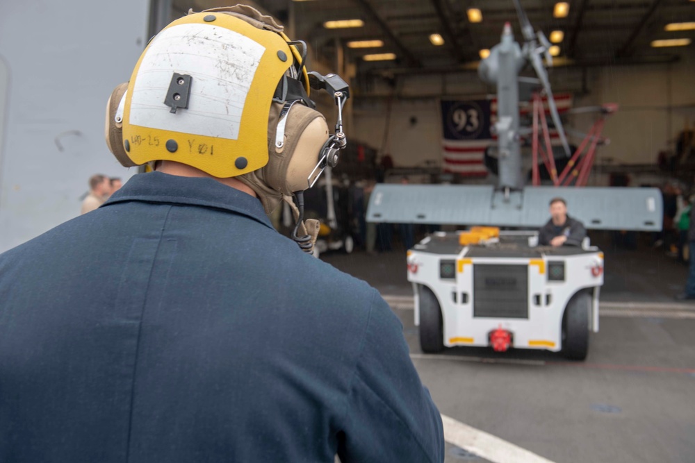Sailor directs a helicopter on the flight deck USS Somerset