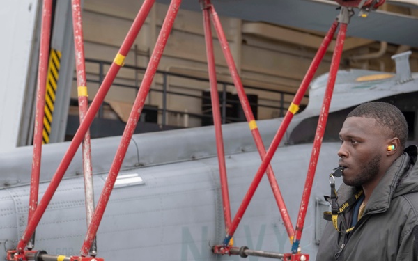 Sailor directs a helicopter on the flight deck Aboard USS Somerset