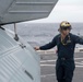 Sailor directs a helicopter on the flight deck Aboard USS Somerset