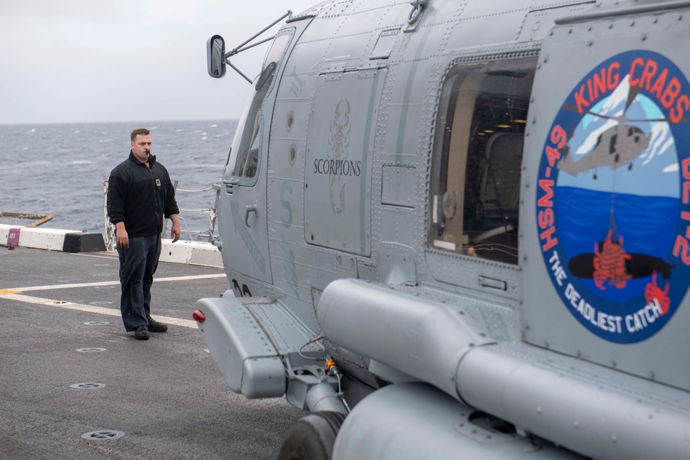 Sailor directs a helicopter on the flight deck of  USS Somerset