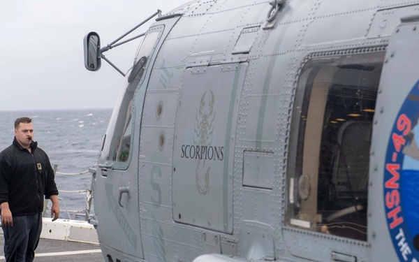 Sailor directs a helicopter on the flight deck of  USS Somerset