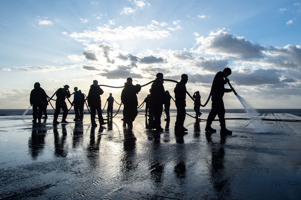 U.S. Sailors conduct a countermeasure washdown