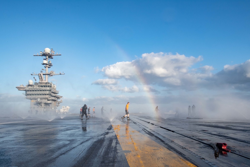 U.S. Sailors conduct a countermeasure washdown