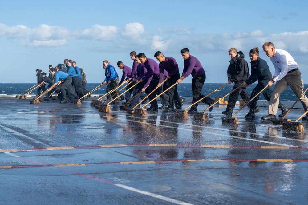 U.S. Sailors conduct a countermeasure washdown