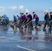 U.S. Sailors conduct a countermeasure washdown