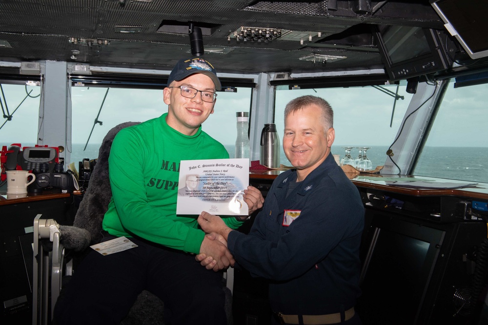 U.S. Sailor poses as Sailor of the Day