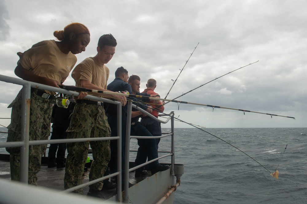 Sailors participate in a fishing call