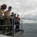 Sailors participate in a fishing call