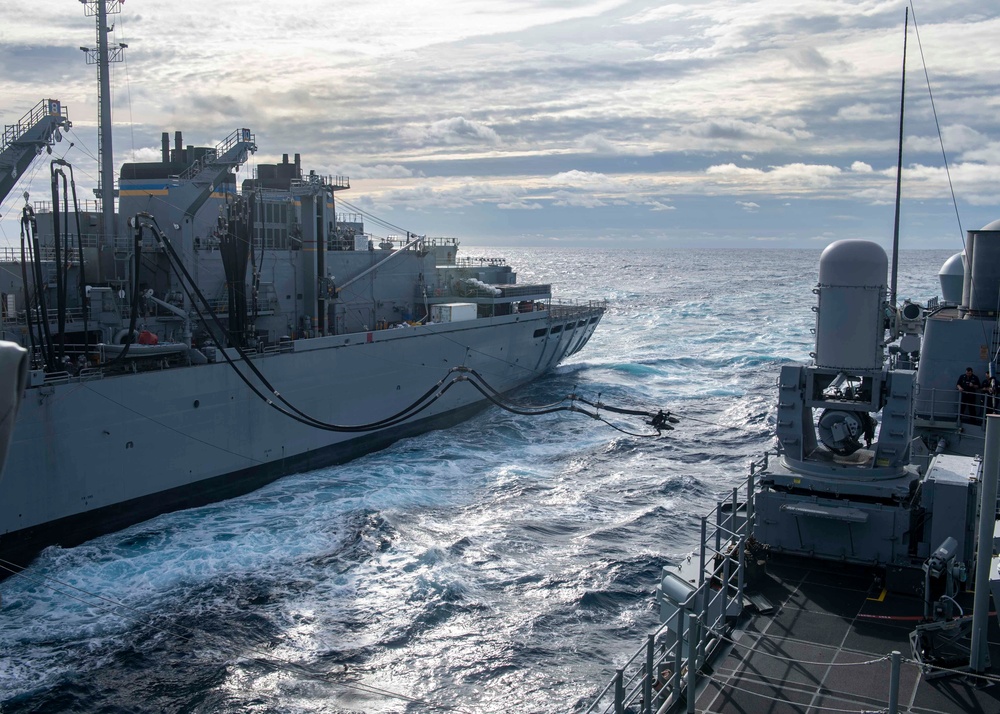 USS Normandy Conducts Replenishment At Sea