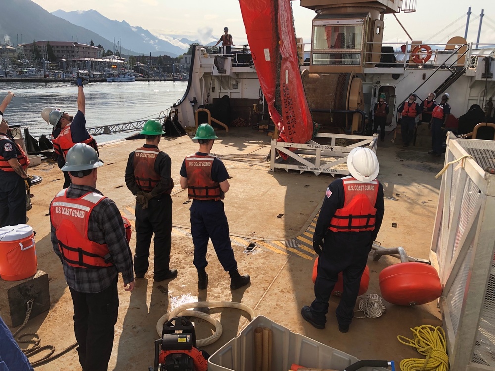 Coast Guard members conduct Spilled Oil Recovery System deployment training in Sitka, Alaska