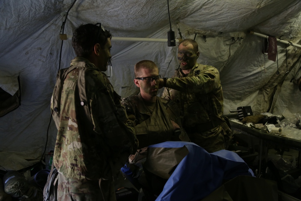 U.S. Soldiers treat a simulated casualty during Saber Junction 19