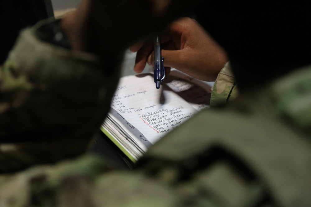 A U.S. Soldier reads their notes in a tactical operations center during Saber Junction 19