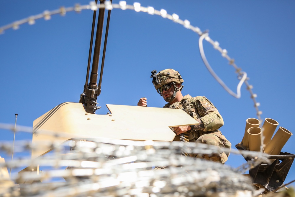 U.S. Army Spc. Aaron Sanders reloads a 50 Caliber Machine Gun during Saber Junction 19