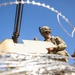 U.S. Army Spc. Aaron Sanders reloads a 50 Caliber Machine Gun during Saber Junction 19