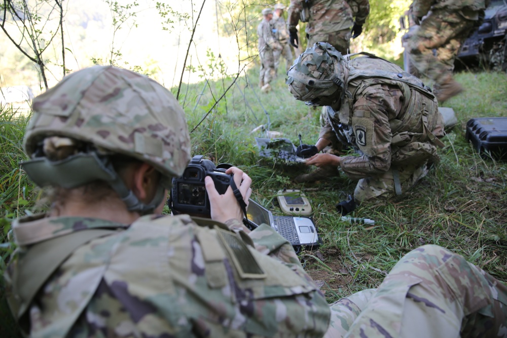 U.S. Army Spc. Meagan Mooney takes a photo during Saber Junction 19