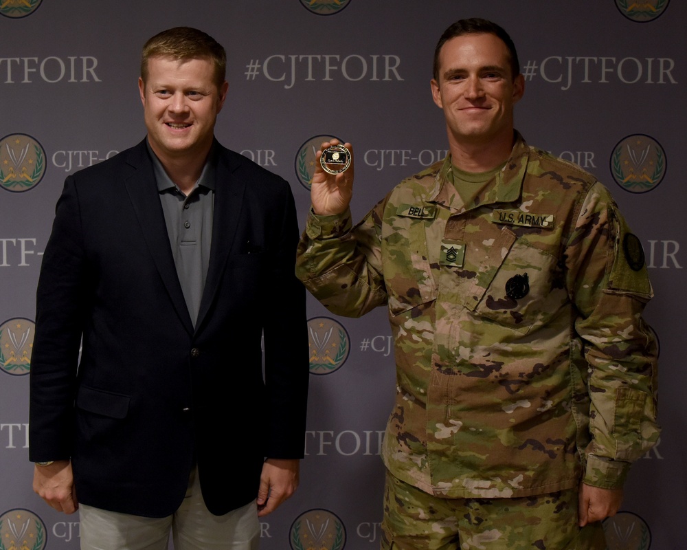 Acting Secretary of the Army coins Sgt. 1st Class Steven Bell