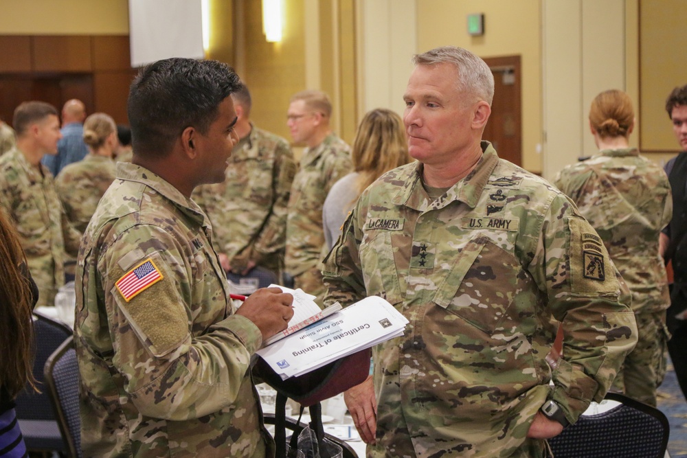 Lieutenant General Paul J. LaCamera, Commanding General of XVIII Airborne Corps and Fort Bragg, speaks with Staff Sergeant Alvin Singh