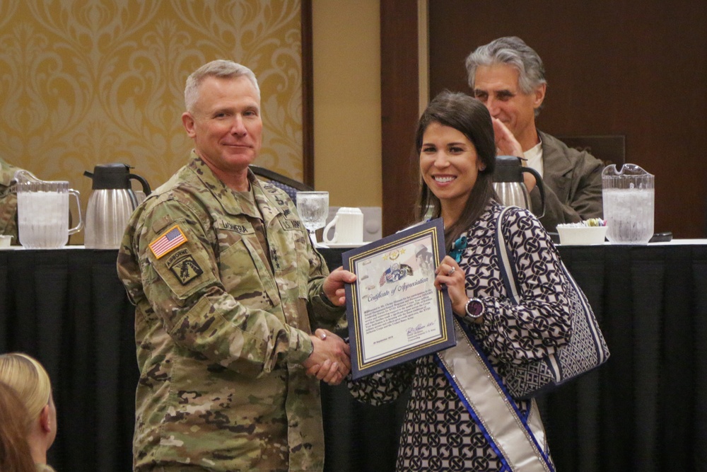 Christy Hinnant is presented a Certificate of Appreciation by Lieutenant General Paul J. LaCamera, Commanding General of XVIII Airborne Corps and Fort Bragg