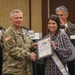 Christy Hinnant is presented a Certificate of Appreciation by Lieutenant General Paul J. LaCamera, Commanding General of XVIII Airborne Corps and Fort Bragg