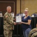 Specialist Kristen Thweatt is presented a Certificate of Appreciation by Lieutenant General Paul J. LaCamera, Commanding General of XVIII Airborne Corps and Fort Bragg