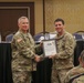 Master Sergeant Joshua Brown is presented a Certificate of Appreciation by Lieutenant General Paul J. LaCamera, Commanding General of XVIII Airborne Corps and Fort Bragg