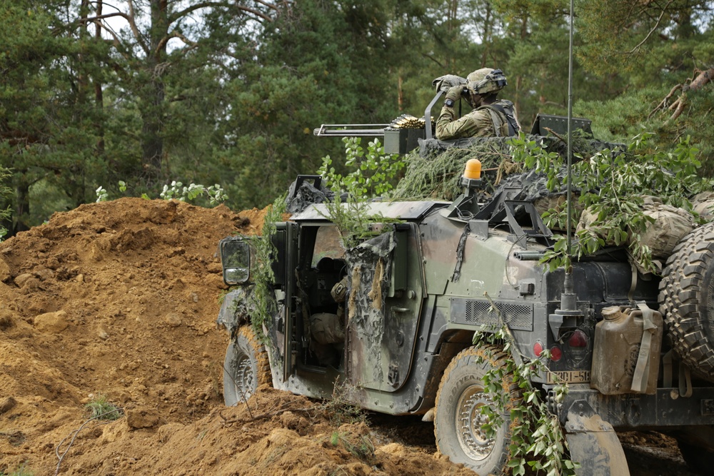 U.S. Soldiers scan sectors of fire during Saber Junction 19