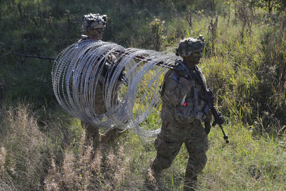 U.S. Soldiers move concertina wire during Saber Junction 19